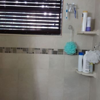 Euceda Flooring - a tiled bathroom with a window - Flooring Near Me