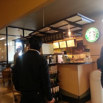 Starbucks - a man and a woman standing in a coffee shop - Coffee & Tea Near Me - Calgary, Alberta Starbucks - a man and a woman standing in a coffee shop - Coffee & Tea Near Me - Calgary, Alberta