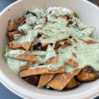 CAVA - Tahini sauce covered pita chips in my honey's chicken bowl - Mediterranean Near Me - La Jolla, California CAVA - Tahini sauce covered pita chips in my honey's chicken bowl - Mediterranean Near Me - La Jolla, California