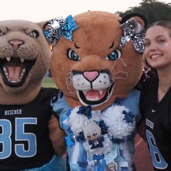 Bishop Louis Reicher Catholic School - School spirit on full display! One of our students poses with the Cougar mascots, showcasing the energy and pride of our athletic community.