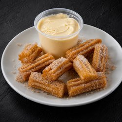 Golden, filled bite-sized churros coated in cinnamon sugar, served with your choice of dip, and added ice cream on the side.