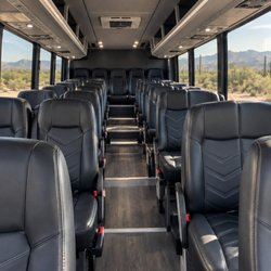 Tribute Transportation - Premium shuttle interior with individual black leather passenger seats.