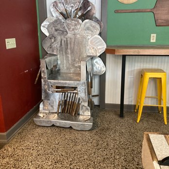 Parkway Pizza - a metal sculpture of a man holding a knife - Pizza Near Me - Minneapolis, Minnesota