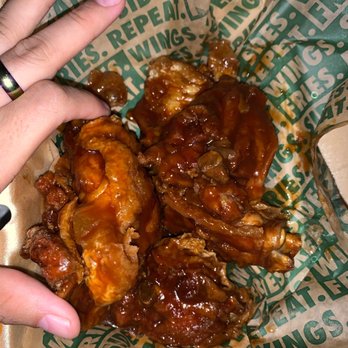 Wingstop - a person's hand grabbing a piece of chicken wings - Chicken Wings Near Me - Seffner, Florida Wingstop - a person's hand grabbing a piece of chicken wings - Chicken Wings Near Me - Seffner, Florida