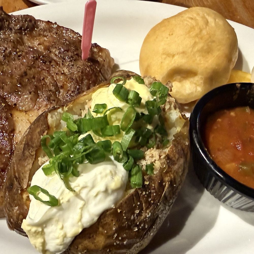 Indian Creek Steakhouse - Wagyu ribeye cooked medium rare w/ a fully loaded baked potato and Indian fry bread - Steakhouses Near Me - Caldwell, Idaho Indian Creek Steakhouse - Wagyu ribeye cooked medium rare w/ a fully loaded baked potato and Indian fry bread - Steakhouses Near Me - Caldwell, Idaho