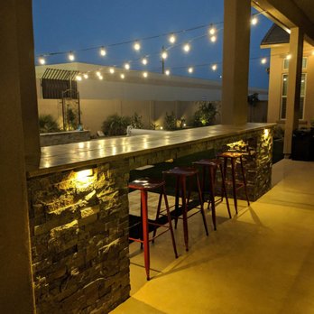 Unique Landscapes & Custom Pools - Outdoor kitchen/bar at night - Landscape Architects or Designers Near Me - Chandler, Arizona Unique Landscapes & Custom Pools - Outdoor kitchen/bar at night - Landscape Architects or Designers Near Me - Chandler, Arizona