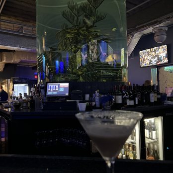 Dive Bar Restaurant - Espresso Martini and Eel in the tank behind the bar. - Seafood Near Me - Jupiter, Florida Dive Bar Restaurant - Espresso Martini and Eel in the tank behind the bar. - Seafood Near Me - Jupiter, Florida