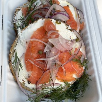 Apollo Bagels - a close up of a bagel topped with salmon and onions - Bagels Near Me - New York, New York Apollo Bagels - a close up of a bagel topped with salmon and onions - Bagels Near Me - New York, New York