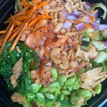 PokePro - A poke bowl featuring salmon, shredded carrots, cucumbers, onions, seaweed, fried onions, and crispy toppings in a black plastic container. - Poke Near Me - Norwalk, Connecticut