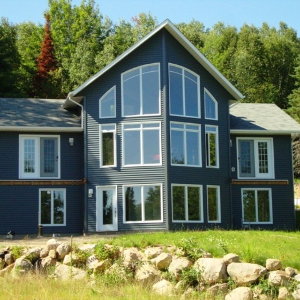 Marcel Degagne Carpentry - a blue house with large windows - General Contractors Near Me - Corbeil, Ontario Marcel Degagne Carpentry - a blue house with large windows - General Contractors Near Me - Corbeil, Ontario