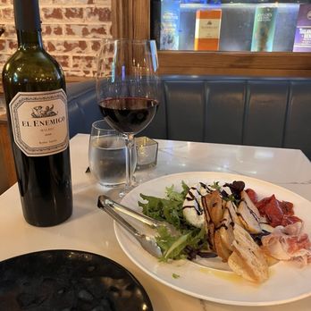 Bia Kitchen - Burrata and prosciutto appetizer and a bottle of Malbec - Modern European Near Me - Purcellville, Virginia