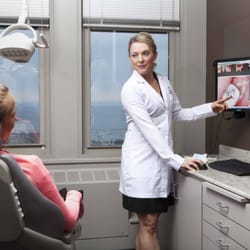 MG Dentistry & Rejuvenation Center - An MG Dental Hygienist using state-of-the-art tools to improve the patient's oral health.