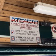 Photo of Maximo Gomez Park / Domino Park - Miami, FL, United States. Sign says: To all members and visitors. No alcoholic beverages are allowed in the park. No one under the influence of alcohols is permitted