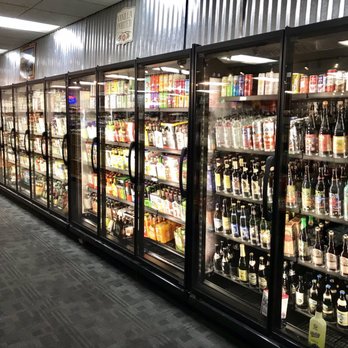 Smooth Endings - a row of beer bottles in a cooler - Beer, Wine & Spirits Near Me - Saint Joseph, Missouri