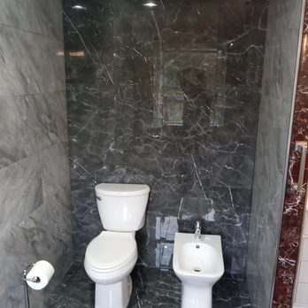 Feeney Construction - a bathroom with a toilet and a bidet - Windows Installation Near Me Feeney Construction - a bathroom with a toilet and a bidet - Windows Installation Near Me