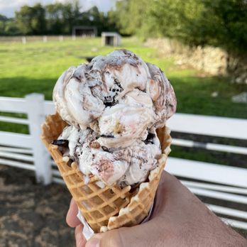 Simcock Farm - a hand holding an ice cream cone - Farmers Market Near Me - Swansea, Massachusetts