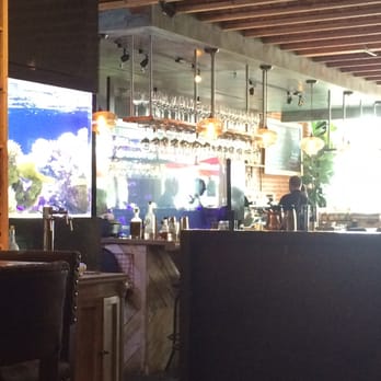 Lechon - Bar with salt water fish tank to the side and a jelly fish tank behind the bar. Love it! - Tapas Bars Near Me - Portland, Oregon Lechon - Bar with salt water fish tank to the side and a jelly fish tank behind the bar. Love it! - Tapas Bars Near Me - Portland, Oregon