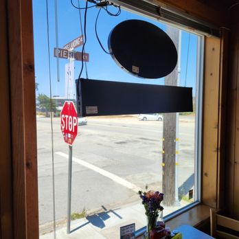 Moss Landing Cafe - Inside looking at the street sign outside June 2025 - American Near Me - Moss Landing, California