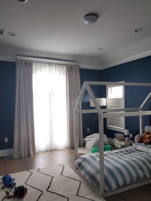 Warmth, Blackout and Privacy for Children's Bedroom! - Our client needed a way to provide her child with as much room darkening as possible! We recommended curtains for the arch window, due to gaps even with a specialty shape window treatment. Sheers added to a double rods system helps with privacy during the day without having the room pitch dark! We matched the two windows on the sides with Hunter Douglas Solera Shades for more darkening and privacy solutions! The top down bottom up function helps with keeping daylight available without losing privacy! Warmth, Blackout and Privacy for Children's Bedroom! - Our client needed a way to provide her child with as much room darkening as possible! We recommended curtains for the arch window, due to gaps even with a specialty shape window treatment. Sheers added to a double rods system helps with privacy during the day without having the room pitch dark! We matched the two windows on the sides with Hunter Douglas Solera Shades for more darkening and privacy solutions! The top down bottom up function helps with keeping daylight available without losing privacy!