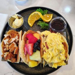 Pancake street tacos with chicken, fruit and eggs. I had more fruit as a side with it.  Various filling options available.