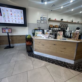 Teaspoon - Inside - Interior of a cafe featuring a wooden counter, digital menu display, and an  - Bubble Tea Near Me - Mansfield, Texas