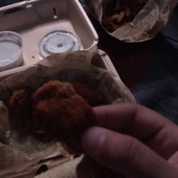 a hand holding a piece of food a hand holding a piece of food