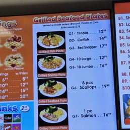 Posted restaurant menu with the price of Grilled Seafood Plate including choice of side (no additional charge). Posted restaurant menu with the price of Grilled Seafood Plate including choice of side (no additional charge).
