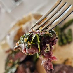 OTH Chophouse - A piece of Marinated 10 oz Hanger Steak with Chimichurri. Served with Baked Potato and Asparagus.