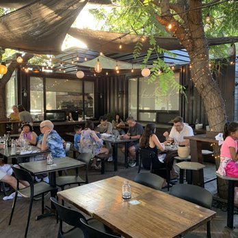 Benchmark - Open air dining under a canopy - New American Near Me - Santa Ana, California
