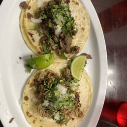 Corn tortilla tacos. One asada and one carnitas. Corn tortilla tacos. One asada and one carnitas.