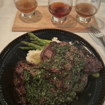 Currents Restaurant - 16 oz Ribeye, garlic mashed potatoes with asparagus and a flight of cheese fused bourbons. - Seafood Near Me - Tarpon Springs, Florida Currents Restaurant - 16 oz Ribeye, garlic mashed potatoes with asparagus and a flight of cheese fused bourbons. - Seafood Near Me - Tarpon Springs, Florida