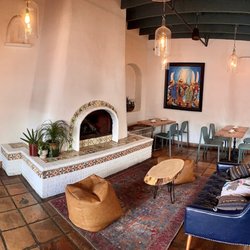 Inka Mama's - Fireplace with tables dispersed for dining.