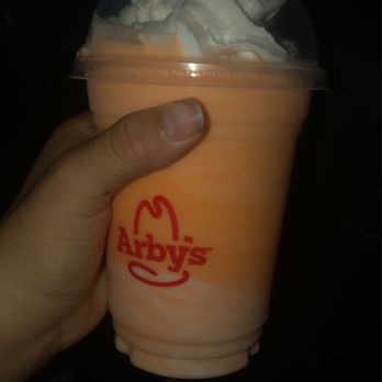 Arby's - a hand holding a cup of ice cream - Fast Food Near Me - Loves Park, Illinois