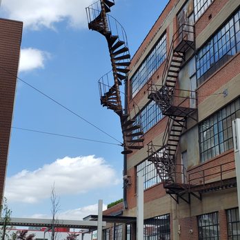 Architectural DNA - Spiral fire escape sculpture titled Architectural DNA between buildings - Public Art Near Me - Oklahoma City, Oklahoma
