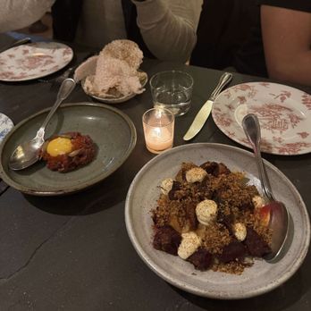 Bateau - Starters: steak tartare on the left and tomatoes with crispy shank, mayonnaise, and bread crumbs on the right. - Steakhouses Near Me - Seattle, Washington