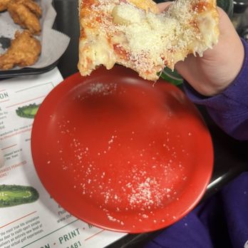 Pizza Como USA - a hand holding a slice of pizza - Pizza Near Me - Temple, Pennsylvania