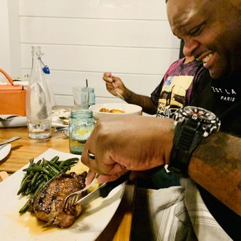 Blackwall Hitch - My hubby throughly enjoying his pork chop. Cooked perfectly. - New American Near Me - Baltimore, Maryland