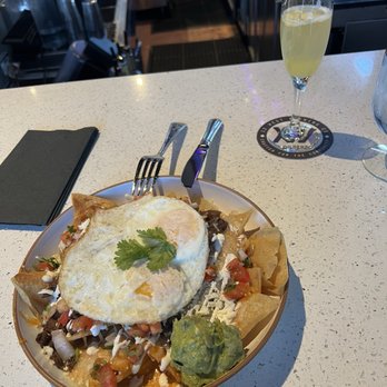 Zona Cantina + Cocina - Red chilaquiles with carne asada and over easy eggs - Mexican Near Me - Mesa, Arizona