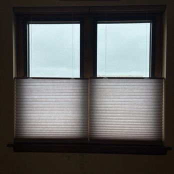 Installations By DC - The shades which I chose - A window with two blinds partially lowered, allowing some light through, with a bear-themed picture above the window. - Shades & Blinds Near Me - Downers Grove, Illinois