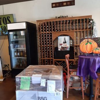 Canyon Crest Winery - a wine cellar with a table and chairs - Wine Bars Near Me - Riverside, California