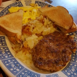 By The Way Cafe - Sausage patty and white buttered toast with sliced potatoes.