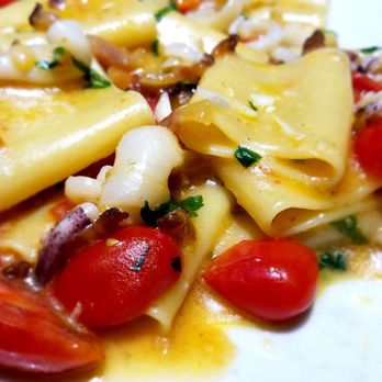 That's Amore - Paccheri with calamari: Wide tube pasta with calamari, pork cheek, cherry tomatoes and pecorino cheese. Takes about 15 to 20 mins to make. - Italian Near Me - Rome, RM That's Amore - Paccheri with calamari: Wide tube pasta with calamari, pork cheek, cherry tomatoes and pecorino cheese. Takes about 15 to 20 mins to make. - Italian Near Me - Rome, RM