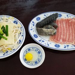 Yun Nan Flavor Garden - Ingredients for the dish - dried tofu skins, bean sprouts, black chicken, slices of pork, a quail egg, and green onions.