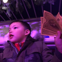 Holding his golden ticket for the actors to stamp and 'make it snow'