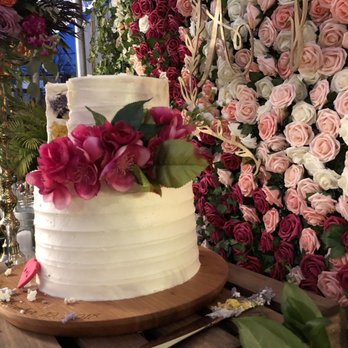 UR Interiors - Pop of color courtesy of the gorgeous flower wall behind our cake - Interior Design Near Me