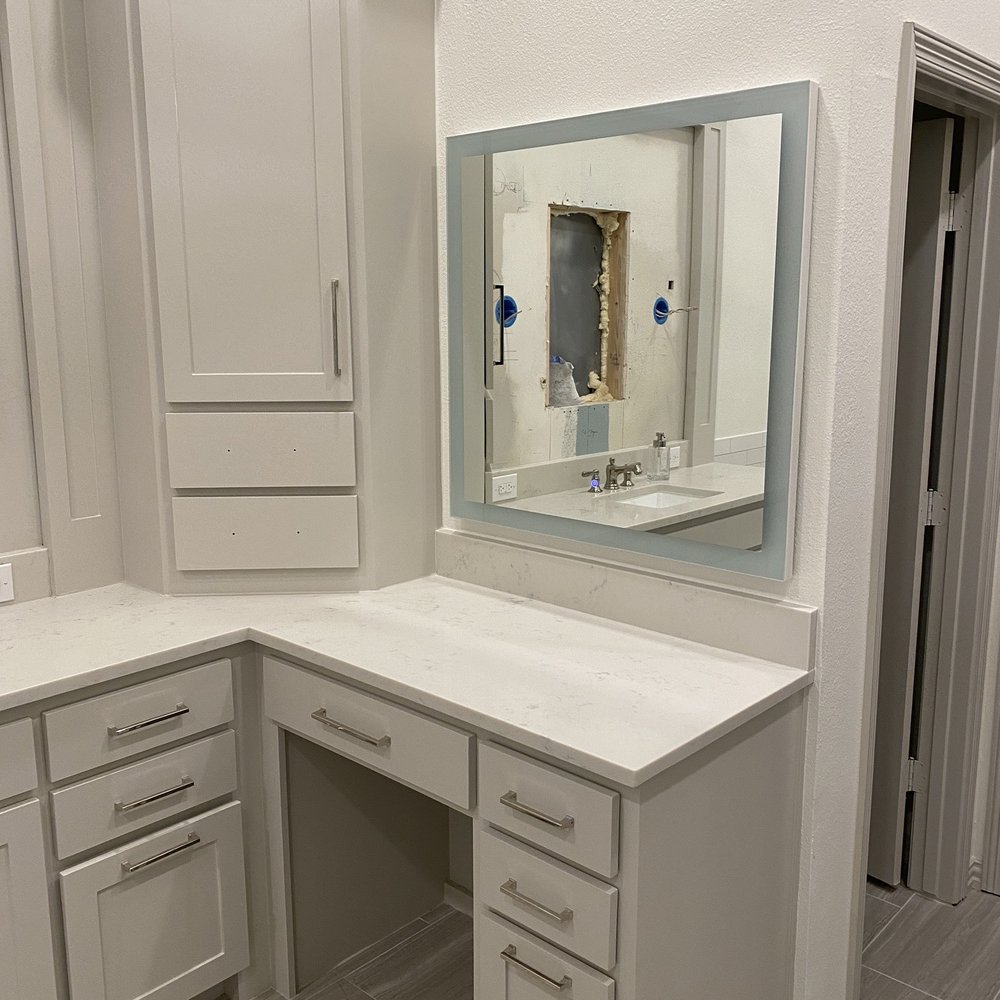 David's Remodeling - a bathroom with a corner vanity - Painters Near Me