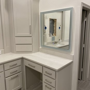 David's Remodeling - a bathroom with a corner vanity - Painters Near Me