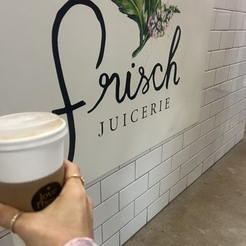Frisch Juicerie - a hand holding a cup of coffee - Coffee & Tea Near Me - Fredericksburg, Texas