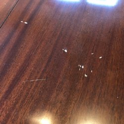 Deep scratches on the antique dining room table