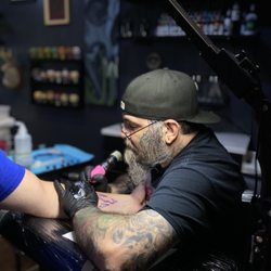 Riot Ink - Artist Scott McClanahan working on a forearm tattoo